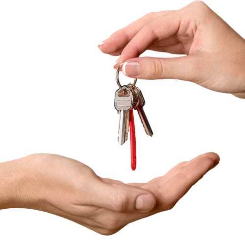 one person handing keys to another person