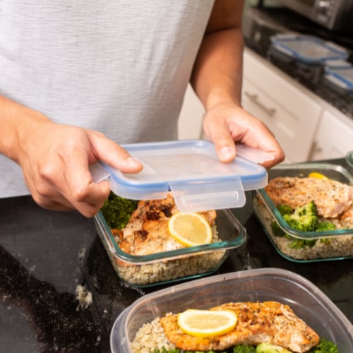 a man storing a week of prepared healthy meals in containers for convenient access later