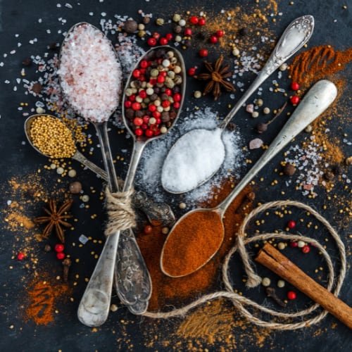 top view of spoons with natural ingredients for adding to foods