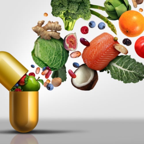 vitamin capsule with assorted healthy vegetables
