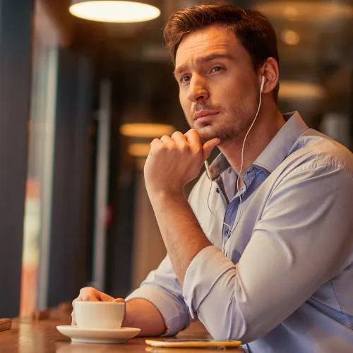 A person engaged in a calm daily routine such as walking, journaling, or quiet reflection, representing the gradual development of emotional resilience over time.