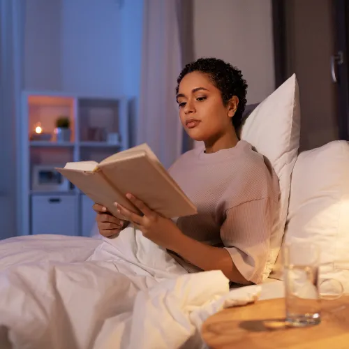 A calm evening routine with consistent habits such as reading, stretching, and low lighting that supports recovery patterns.