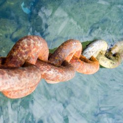 Rusty chain links illustrating the cellular oxidative process.