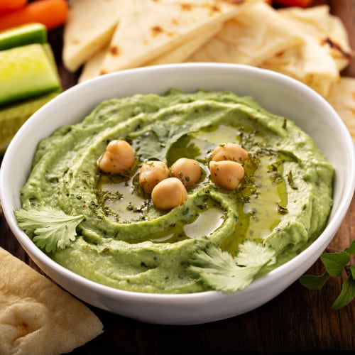 creamy pesto hummus in bowl