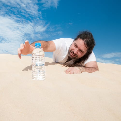 dehydrated man in the desert gasping for water