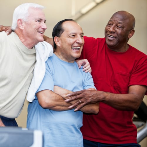 three senior men joyfully posing for a picture