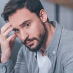 handsome upset man sitting looking stressed