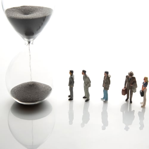 an hourglass emptying and genertions of people depicting time elapse