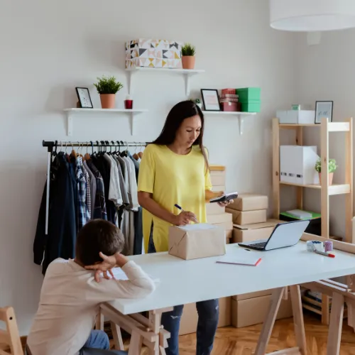 A thoughtful person sitting with a planner, notes, and daily responsibilities spread out around them, reflecting accumulated emotional demands.