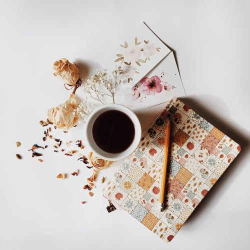 a journal, pen, and cup of coffee for writing down your thoughts
