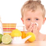 little boy with cold blowing nose into tissue