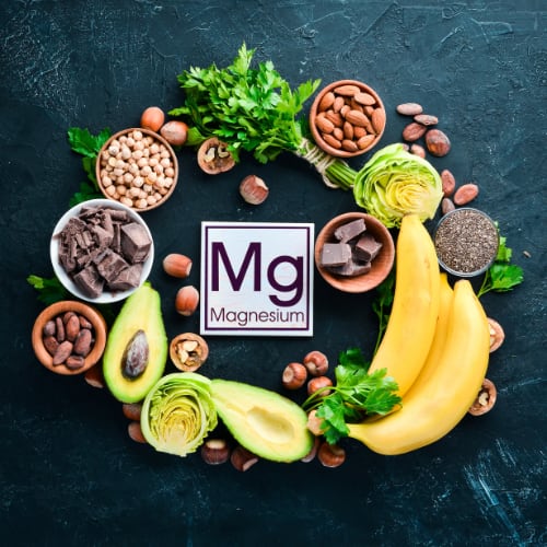 magnesium Mg element surrounded by healthy foods containing magnesium