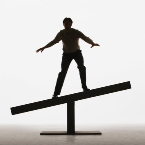 man balancing on a beam