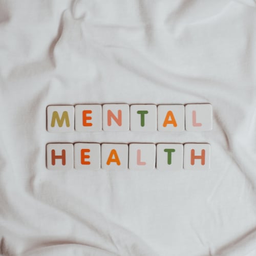 the words mental health spelled out in block letters on a white background