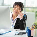 Middle-aged Asian Woman Sitting at Desk