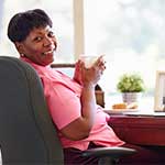 Middle-aged Black Woman Sitting in Office