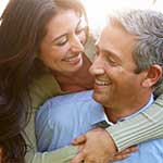 Middle-aged Hispanic Couple Hugging Outside