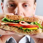 Middle-aged Man Tempted by Sandwich