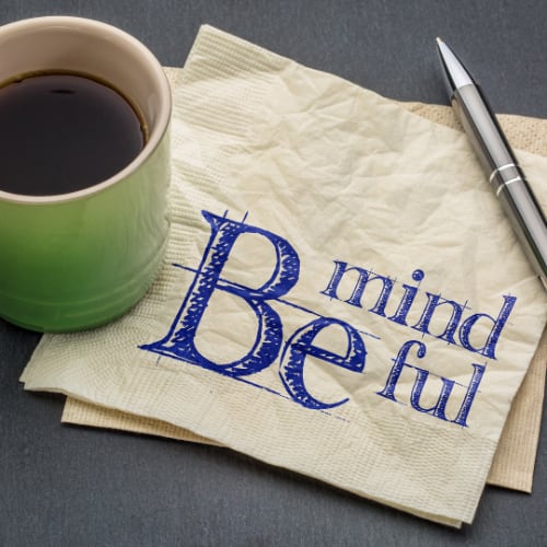 a coffe cup, pen and napkin with the words 