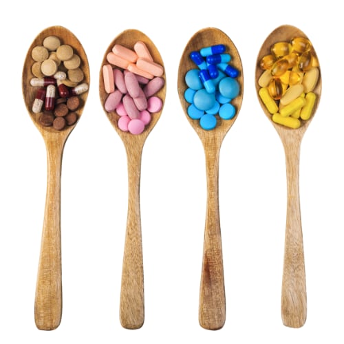 4 wooden spoons each depicting a different multivitamins and mineral supplement