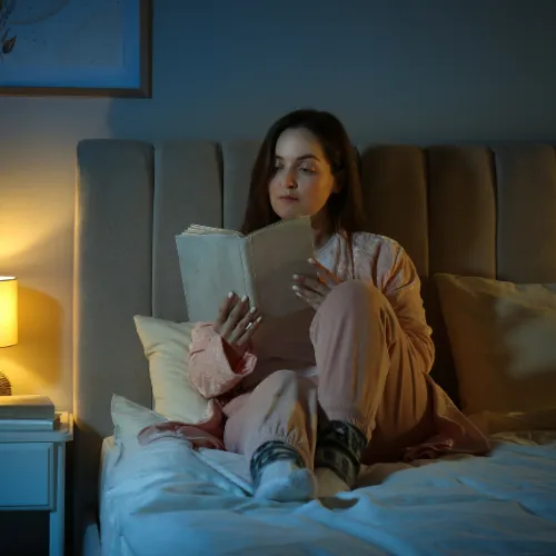 A person sitting quietly in a calm low-stimulation environment without screens or distractions.