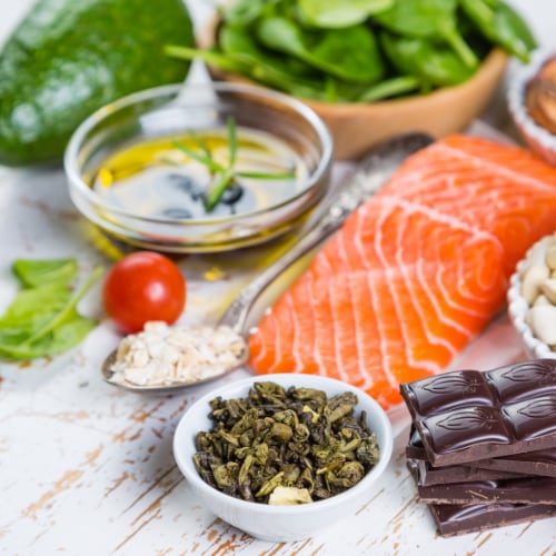 nutrient rich foods including salmon, spinach, nuts, avocado, tomotatoes