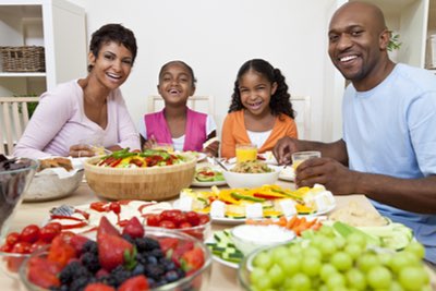 Attractive, young black family enjoying a healthy meal together