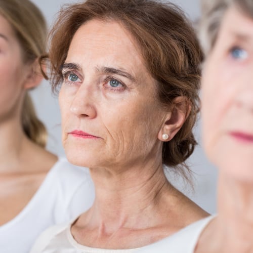 older woman next to two other women of different ages reflecting upon her youth