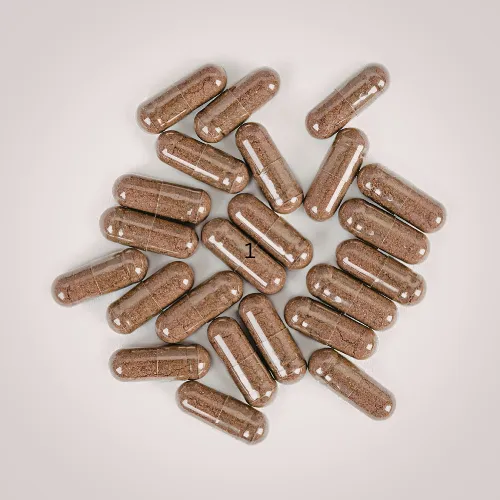 Probiotic and enzyme supplements in capsule form arranged on a neutral background.