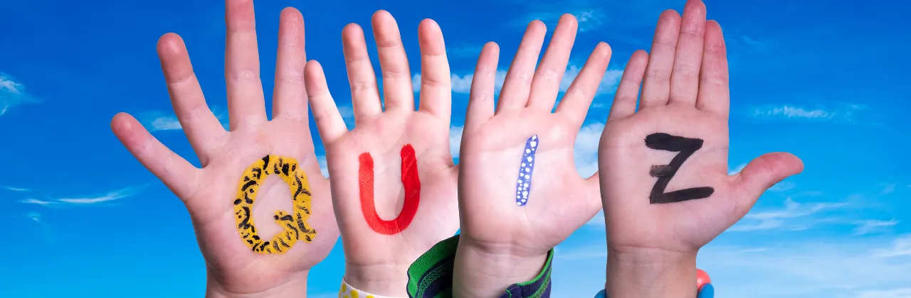 Four hands held up in the air, on a blue sky background, each with one letter, spelling out QUIZ.