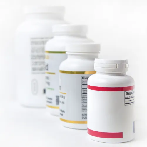 Identical capsules placed beside different supplement bottles to show the same ingredient used across multiple categories.