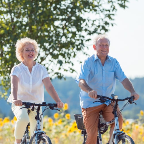 senior couple bike riding depicting fun physical activity