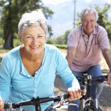 senior couple getting exercise on a fun bike ride