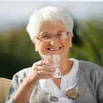 senior woman drinking a glass of water