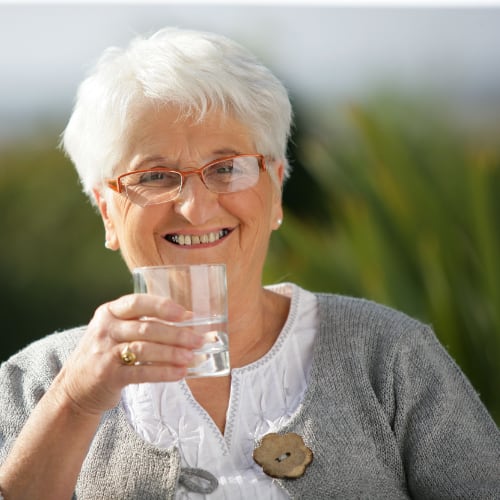 senior woman drinking a glass of water