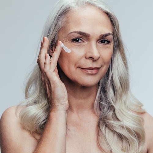 senior woman looking younger using skin care supplementation