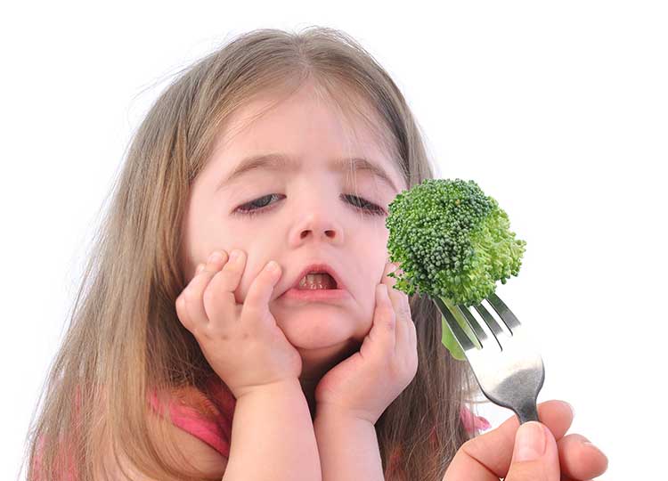 a girl refuses to eat broccoli