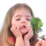 a girl refuses to eat broccoli