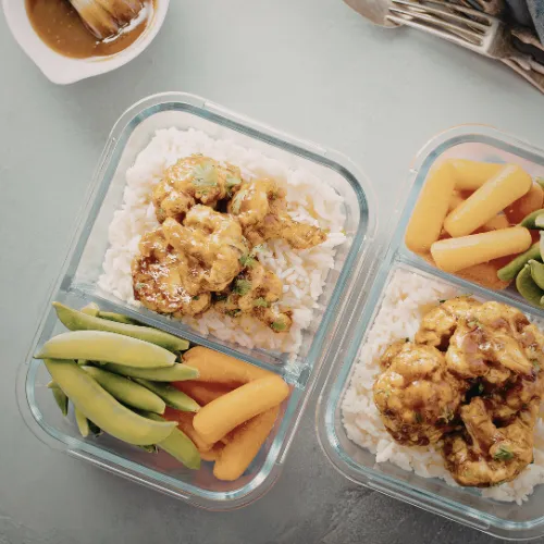 Organized meal prep containers and a written plan showing a structured approach to eating patterns.