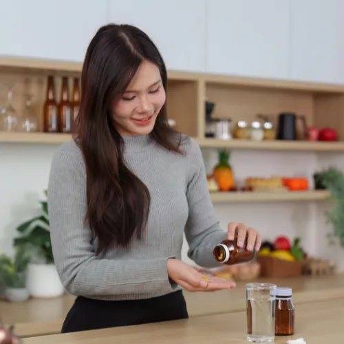 Supplements placed alongside a meal in a home setting, showing how they fit into a daily routine rather than replace it.