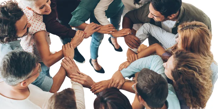a group of people in a circle locking arms next to a set of hands holding a globe
