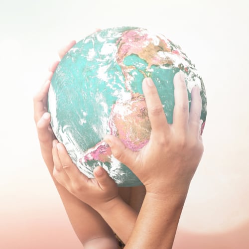 a group of people in a circle locking arms next to a set of hands holding a globe