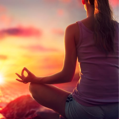 yoga at sunset - woman in meditation - deep breathing