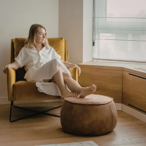 A person relaxing quietly at home in a calm environment that reflects everyday recovery and restoration patterns.