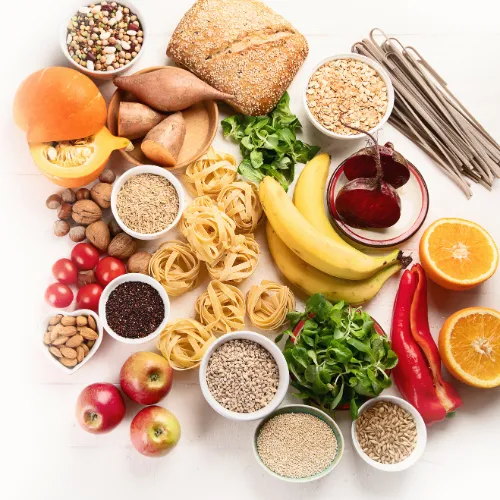 A variety of colorful whole foods arranged together to represent how vitamins and minerals work across shared nutritional patterns.