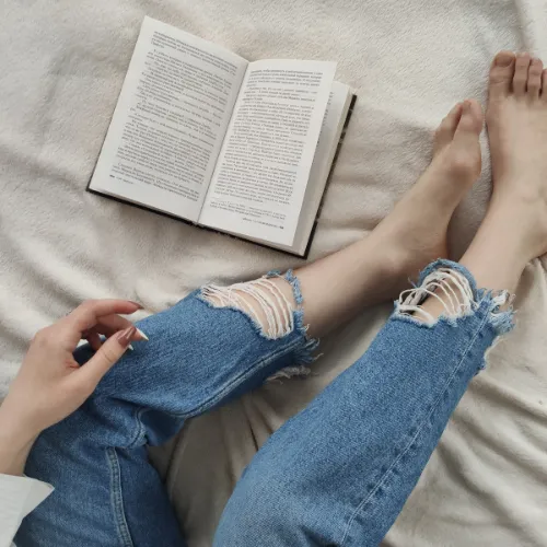A person quietly relaxing at home after a busy day, representing recovery as part of everyday life.