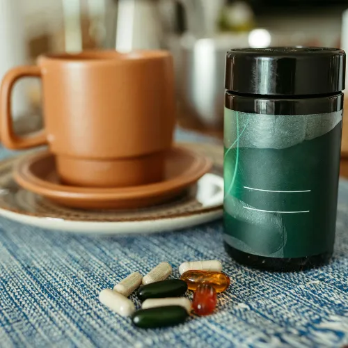 A nighttime recovery routine with supplements, tea, and a calm low-stimulation environment arranged beside a bedside table.