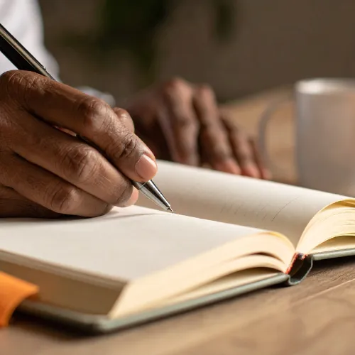 A thoughtful person journaling or reflecting quietly, illustrating the connection between thinking, feeling, and self-awareness.