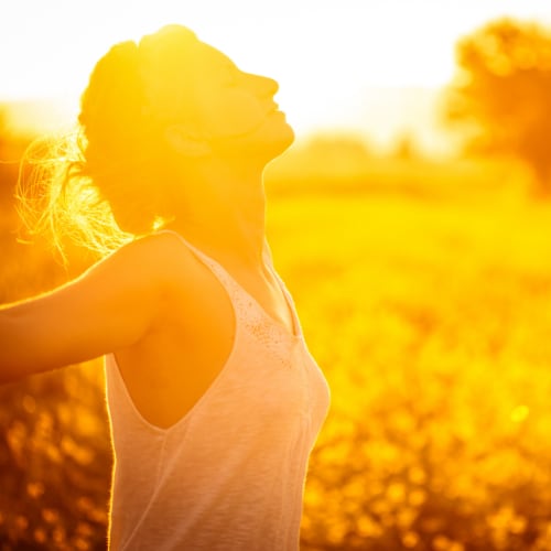 woman outside deep breathing in nature