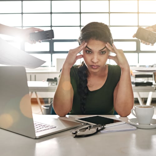 woman overwhelmed by digital distractions from everyday life